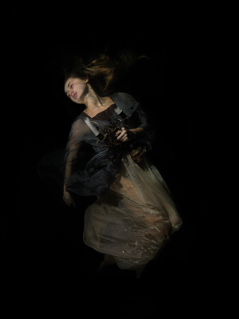 Quiet still life underwater in dim light with surface ripples and photography