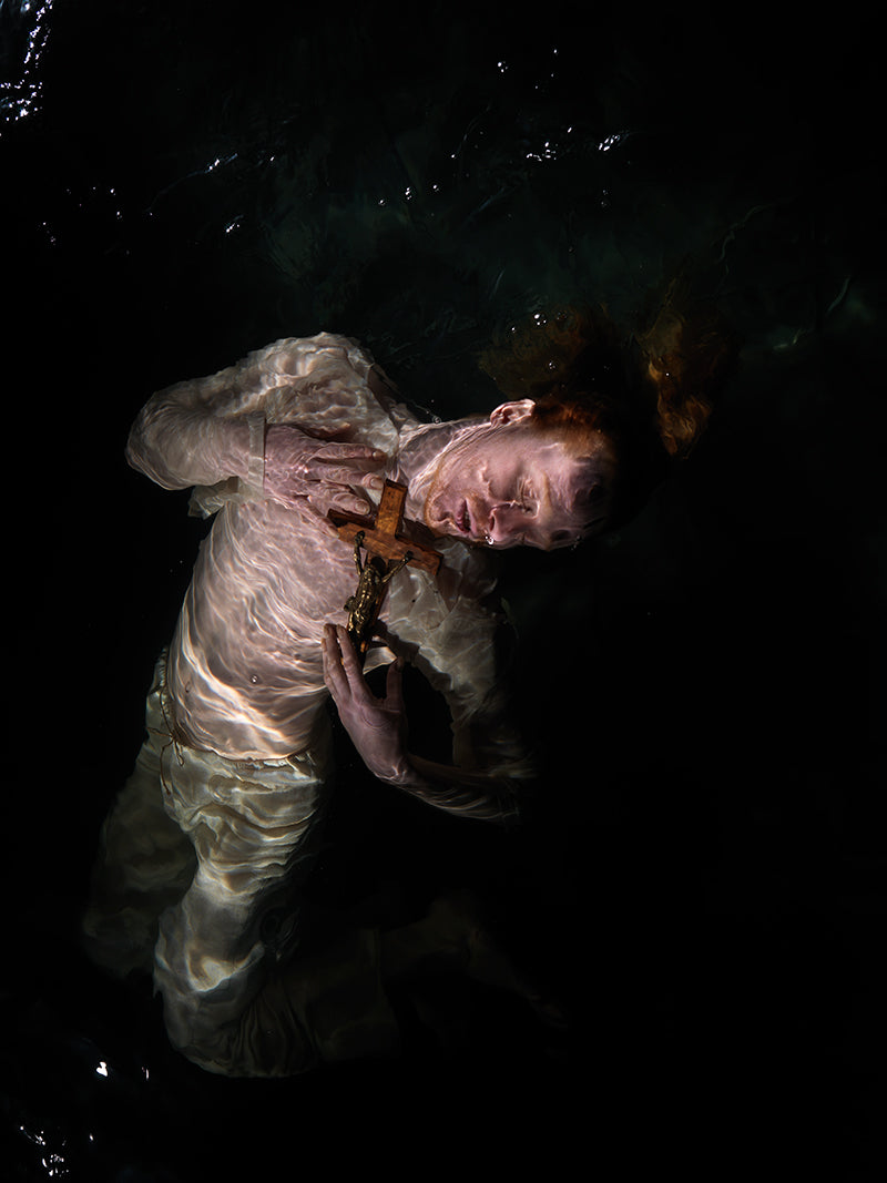 Quiet still life underwater in deep shadow with surface ripples and waters