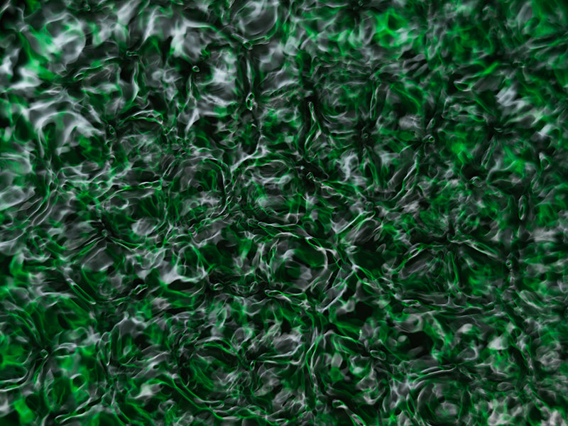 Cymatic pattern held underwater with concentric rings and pale light