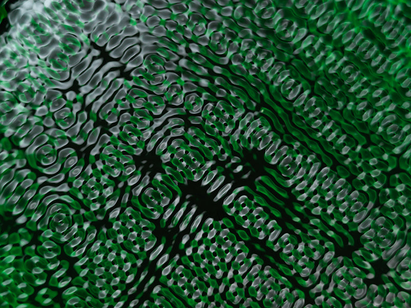 Water harmonics floating underwater with nodal lines in cool shadow