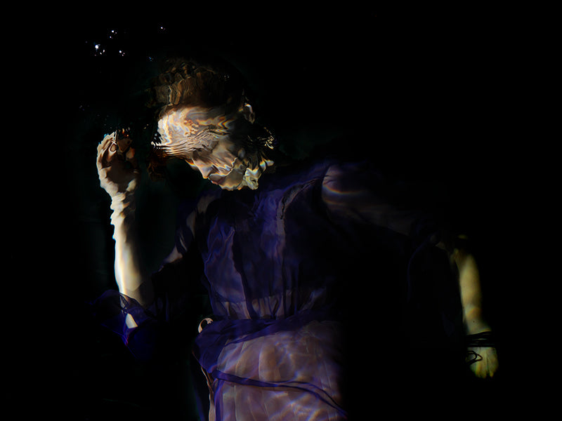 Underwater study underwater in dim light with surface ripples and photography