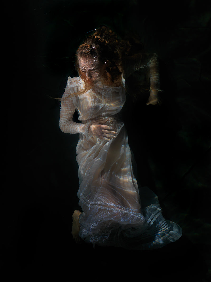 Quiet still life rising underwater with soft refraction in low light
