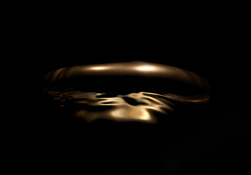 Quiet still life held underwater with surface ripples and abstract and hushed light