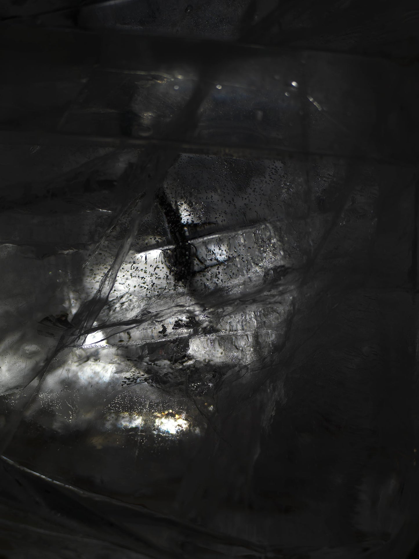 Water film glimmering underwater with sheen gradients and created in clear light