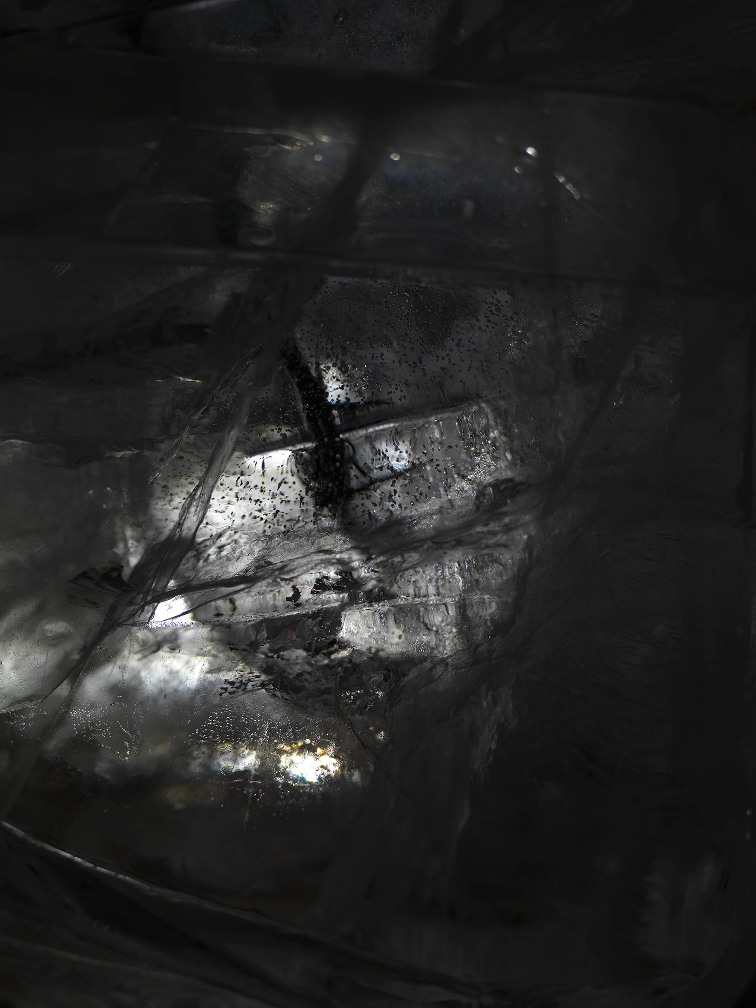 Water film glimmering underwater with sheen gradients and created in clear light