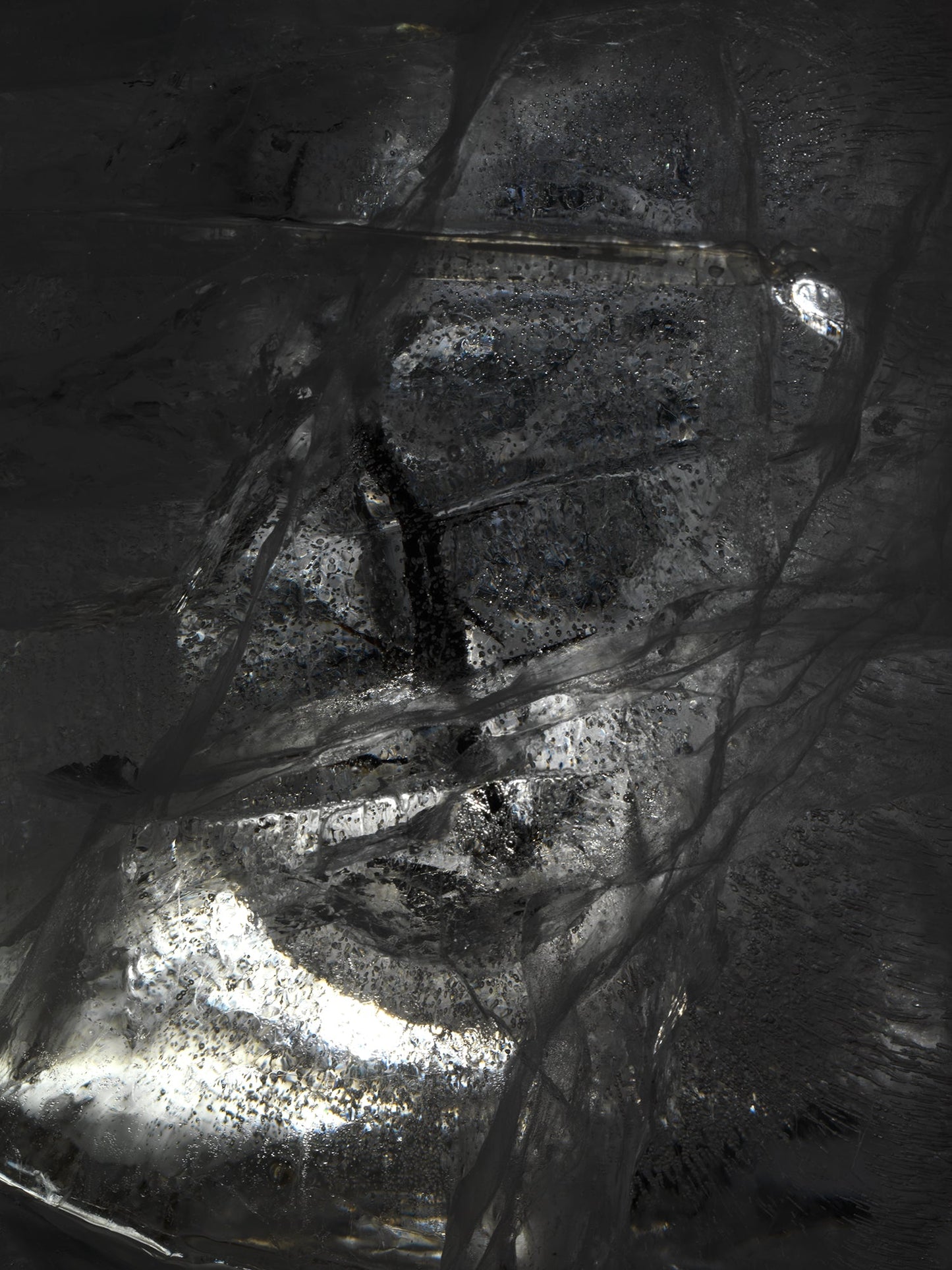 Oil film underwater in deep shadow with swirling film