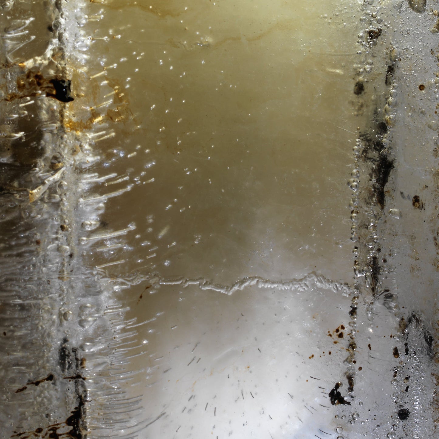 Oil and water held underwater with swirling film and created and deep shadow