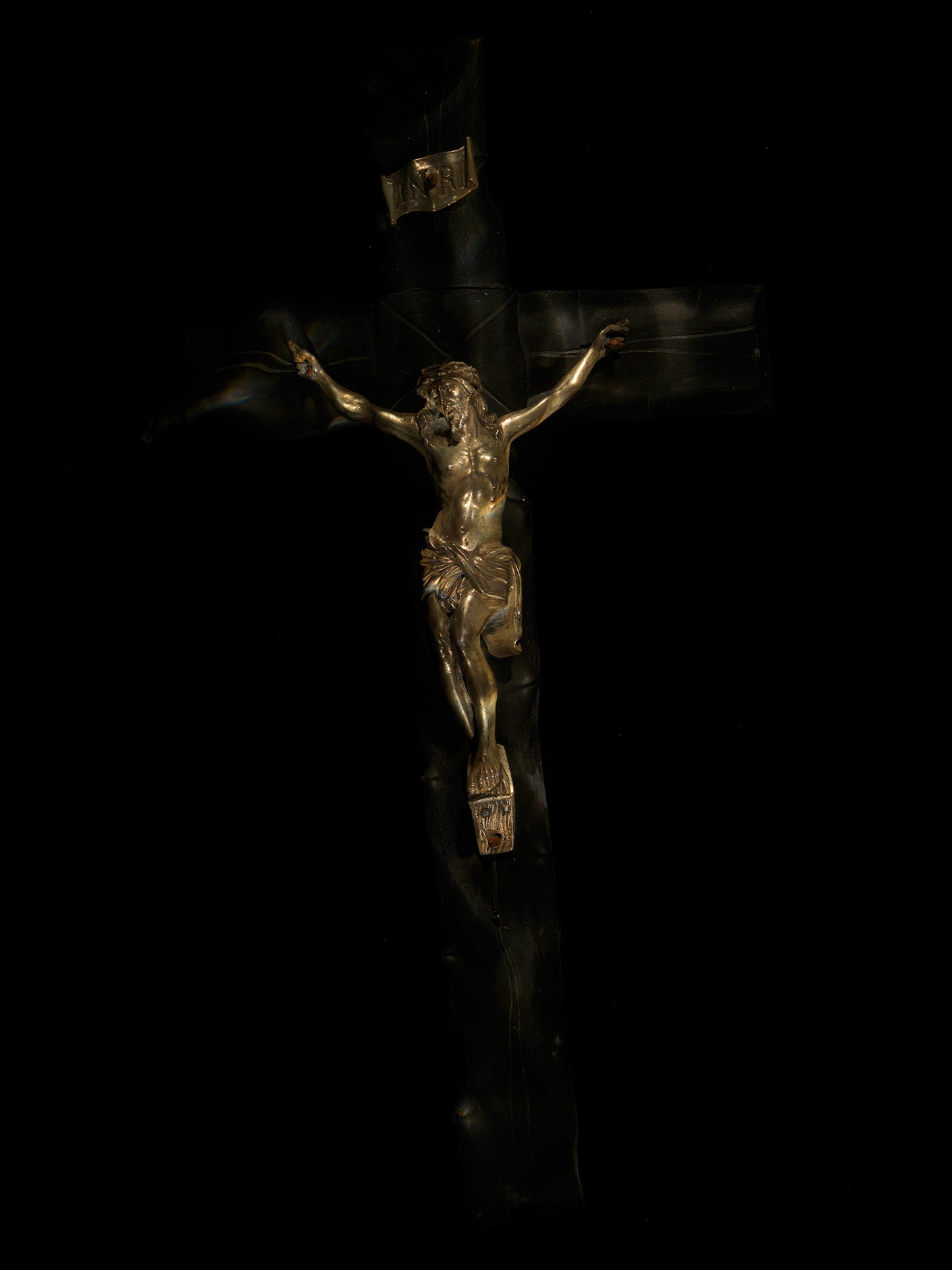Crucifixion splash held underwater with falling droplets and splash and pale light