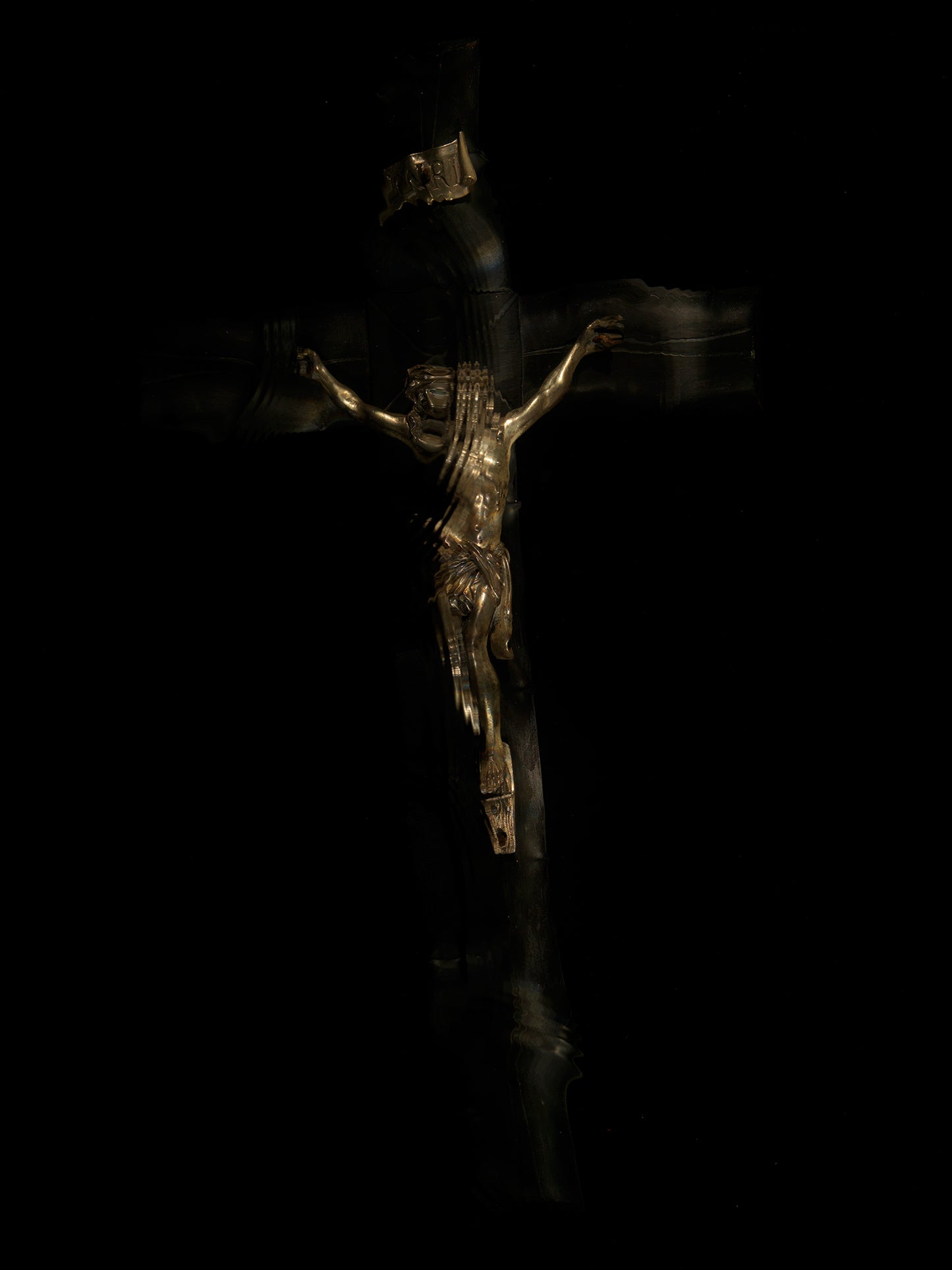 A quiet crucifixion in the dark water