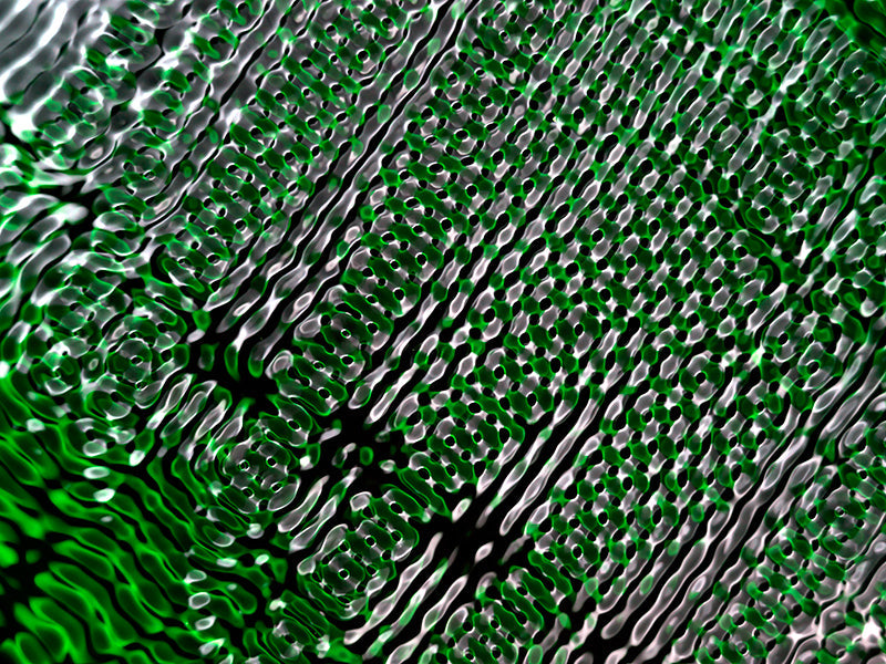 Wave nodes held underwater with nodal lines and cymatic and pale light